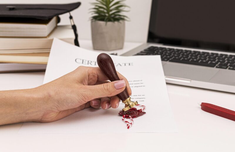 person-using-wax-seal-graduation-diploma-certificate